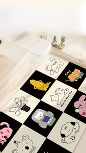 Detail showing non-slip checkered bathroom mat with cute cartoon cats and bears