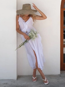 Elegant white ruffle maxi dress with high slit and thin straps for summer beach vacation