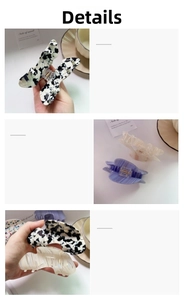 Detail of marble pattern hair claw clips in black, lilac, and beige acetate finishes