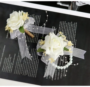 Détail d'une boutonnière rose blanche et d'un corsage de poignet en perles et dentelle