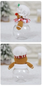 Detail of gingerbread man jar with chef hat and candy container for Christmas decor