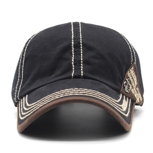 Detail of vintage canvas baseball cap with contrast stitching and retro pegasus metal badge