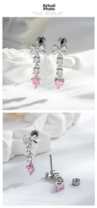 Detail of bowknot stud earrings with hanging pink heart gems and tassel cubic zirconia