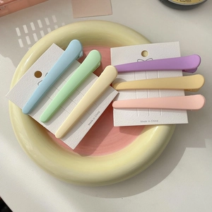 Set of 6 colorful matte candy color duckbill hair clips for women in a decorative bowl