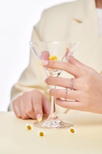 Detailed view of dainty S925 silver rings with colorful cubic zirconia on a hand