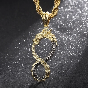 Macro shot of gold and silver dragon pendant forming infinity symbol on a twist chain
