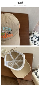Detail of khaki baseball cap with colorful FOR Birdies embroidery and frayed edges