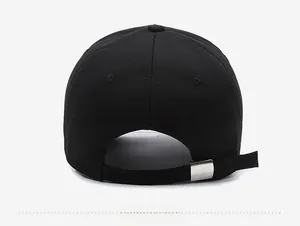 Detail of adjustable metal buckle and twill fabric texture on the back of the black baseball cap