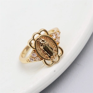 Close-up of golden Virgin Mary relief ring with sparkling zircon side stones