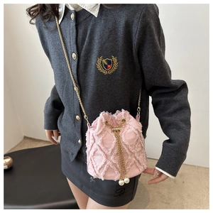 Pink denim bucket bag with quilted texture, gold chain and elegant pearl drawstrings