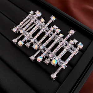 Detail of silver alloy hair clips with AB crystals on black leather display tray