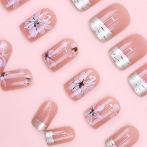 Pink floral press-on nails with silver crescent moon designs in a minimalist layout