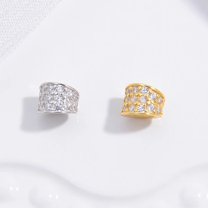 Macro detail of gold and silver S925 spacer beads with pave-set zircon for DIY bracelets
