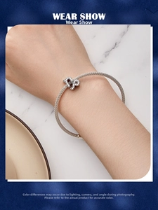 Detailed view of silver mesh bracelet with crystal-studded Capricorn constellation charm