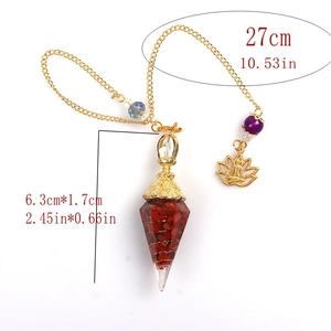 Detail of resin pendulum necklace with red stones and gold lotus pendant showing dimensions