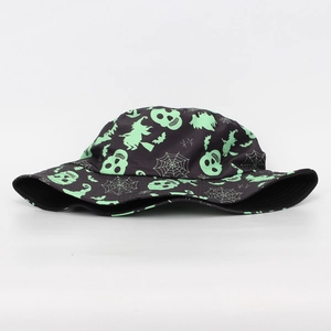 Detail view of Halloween bucket hat with neon green skull and spider web patterns
