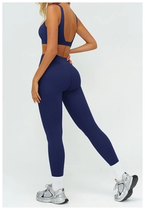 Detail of the open back cutout design on this navy blue high-stretch yoga sports bra