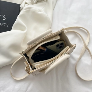 Mini straw crossbody bag in beige with floral detail and interior zipper pocket