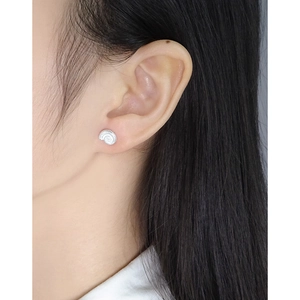 Minimalist S925 sterling silver snail stud earrings worn on female ear for elegant style
