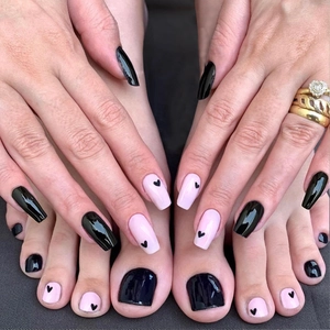 Press-on nail set with black and pink heart patterns for hand and toe nails