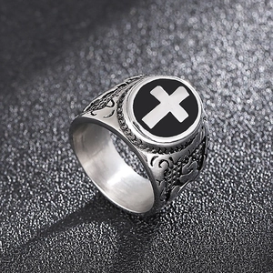 Macro detail of retro stainless steel ring with black enamel and silver cross motif
