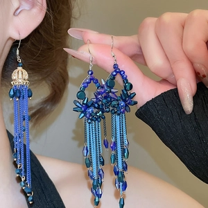 Detail showing elegant long chain tassels and deep blue crystal stones on vintage drop earrings