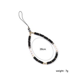 Detail of 28cm handmade black clay bead phone strap with gold accents and LOVE letters