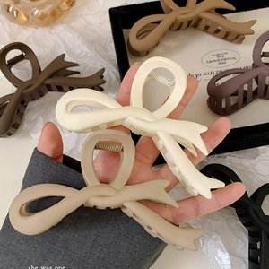 Matte oversized shark clip bow hair claw in earth tones for long hair styling