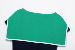 Detail of contrast lapel collar on green and navy blue knitted top in close-up view