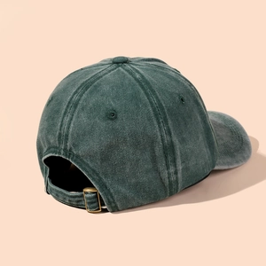 Detail of vintage washed dark green baseball cap with golden metal adjustable buckle strap