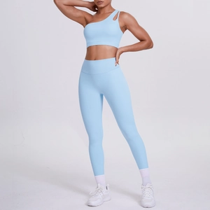 Detail of light blue one-shoulder yoga bra with cutout and matching high-waisted leggings