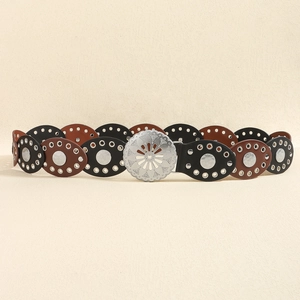 Detail of vintage bohemian PU leather belt with silver hollow oval buckles and rivets