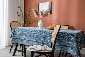 Close-up of blue geometric cotton linen tablecloth in a cozy home dining room scene
