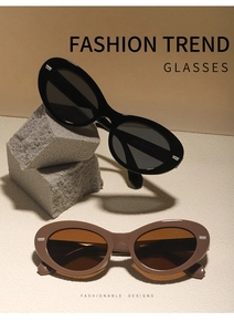 Detail view of retro oval sunglasses in black and brown on minimalist stone props