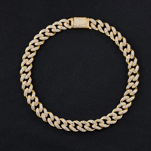 Detailed view of hip hop gold plated Cuban chain necklace with sparkling rhinestones