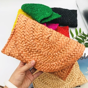 Handmade woven corn husk straw clutch bags available in multiple vibrant colors