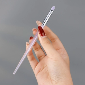 Single makeup brush with purple bristles and iridescent handle shown in hand
