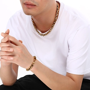 Close-up of gold stainless steel bamboo link chain necklace and bracelet on model