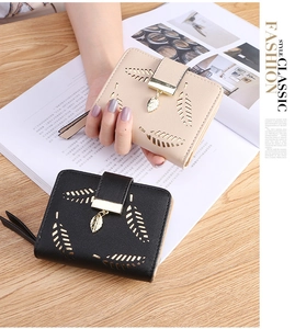 Detail of short PU leather wallets with leaf cutout design and gold leaf pendants