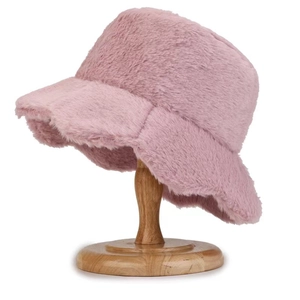Detailed texture of pink faux rabbit fur winter bucket hat on a wooden display stand