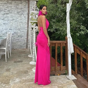 Detail of rose red backless halter dress showing back tie and ruched hip silhouette