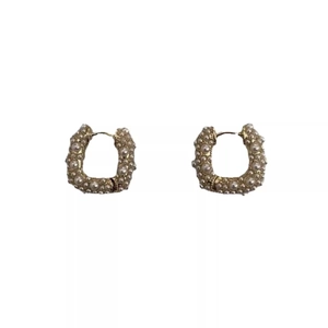 Gold-plated U-shape hoop earrings with rows of inlaid pearls and sparkling stones