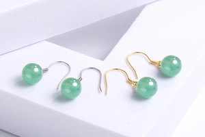 Detail view of round green aventurine beads on elegant gold and silver ear hooks