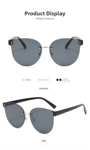 Detail view of oversized rimless sunglasses featuring black lenses and gold metal bridge