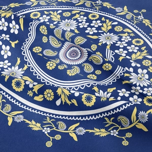Macro shot of dark blue cotton tapestry featuring white and yellow paisley floral patterns