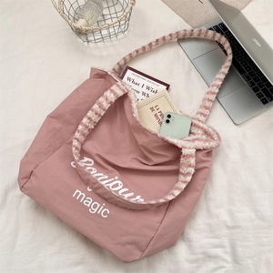 Pink canvas tote bag featuring plush striped straps and Bonjour magic printed lettering