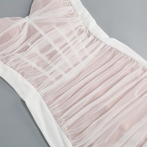 Detailed close-up of white mesh fabric with pink lining and delicate pleated texture
