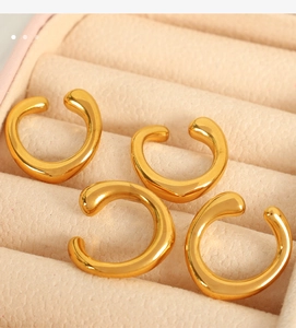 Set of four minimalist gold-finish C-shaped ear cuffs displayed in a premium jewelry box