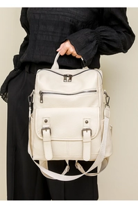 Chic beige soft PU leather backpack with tassel detail and twin straps shown on model