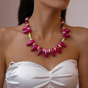 Detail of beaded necklace with purple marble acrylic teardrop charms and gold accents